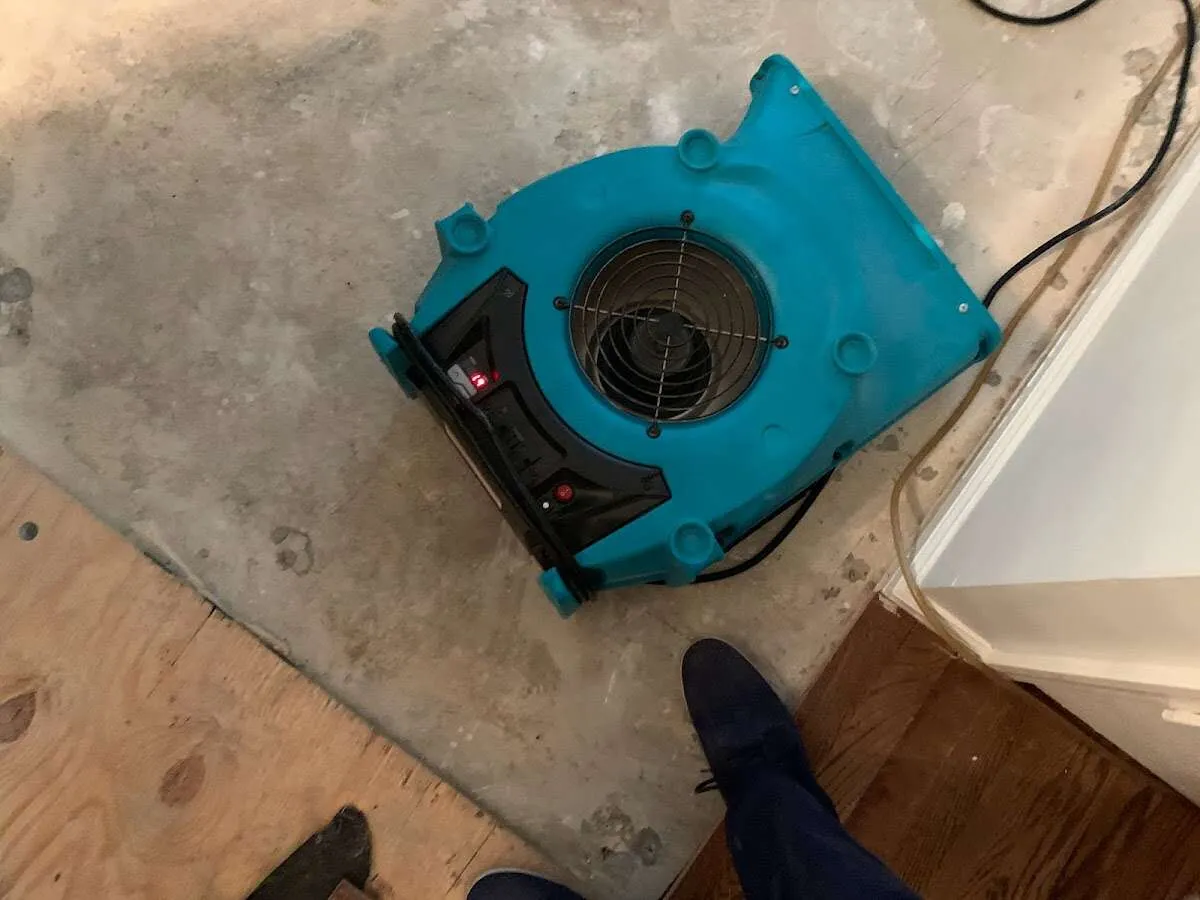 Air mover drying subfloor during Commercial Water Damage Restoration in Belle Fourche